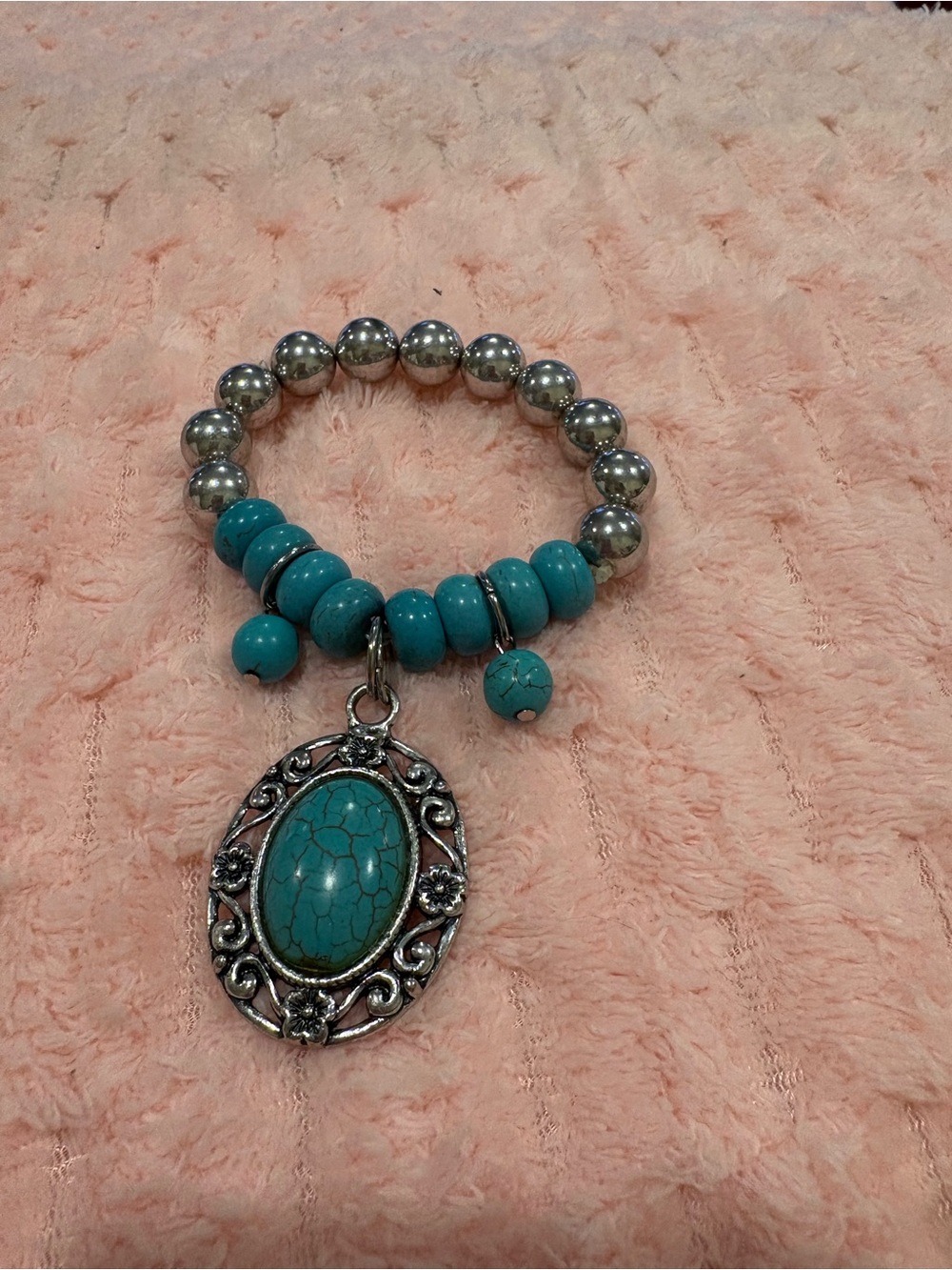 Silver tone faux turquoise fashion stretch bracelet an ornate oval pendant